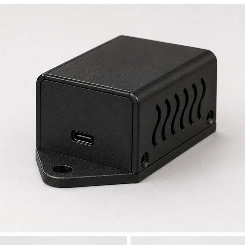 Compact matte black project box featuring side ventilation, USB-C port, and secure flange mounting points. - Image 1